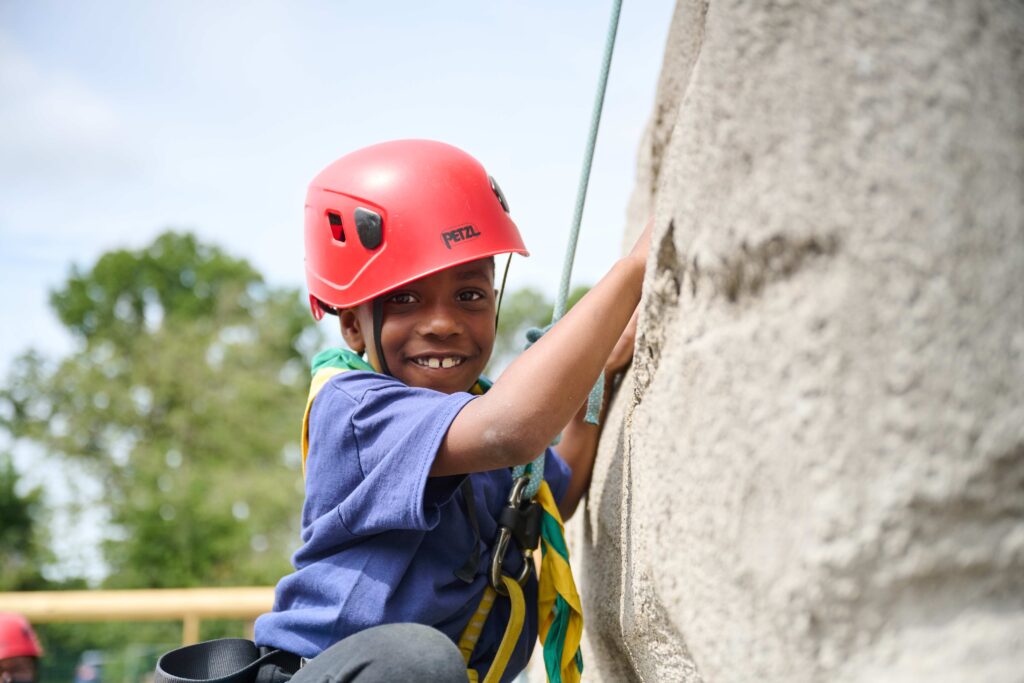 Beaver scout on an outdoor climbing wall